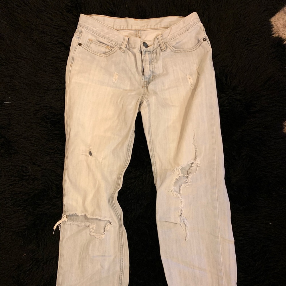 Distressed and worn light wash straight jeans